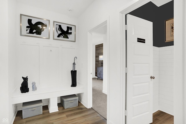 mudroom with wood finished floors and baseboards