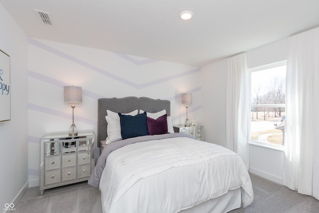 carpeted bedroom with visible vents and baseboards