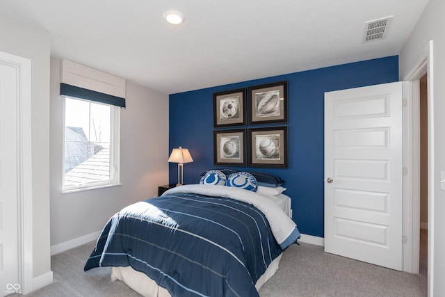 bedroom with visible vents, baseboards, and carpet