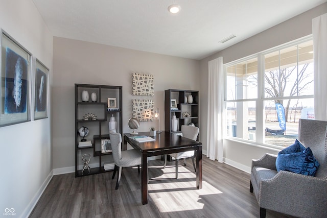 office featuring visible vents, plenty of natural light, baseboards, and dark wood-style floors