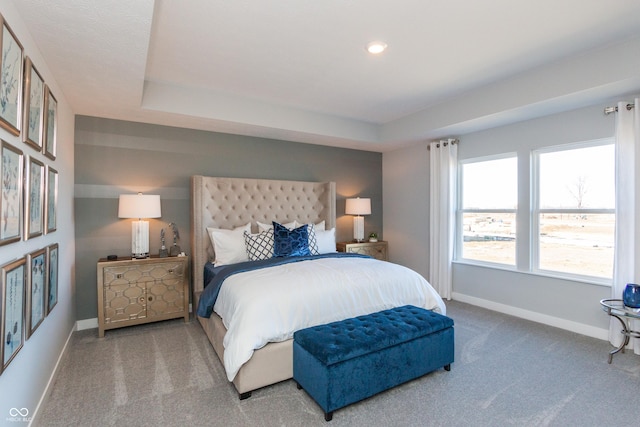 bedroom with recessed lighting, baseboards, a raised ceiling, and carpet flooring