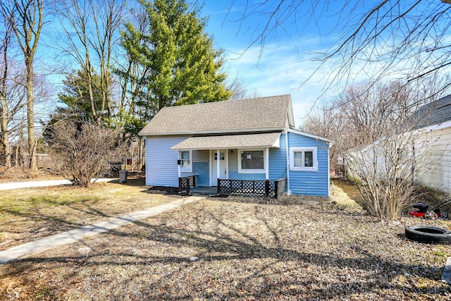 bungalow-style home with a porch and a shingled roof