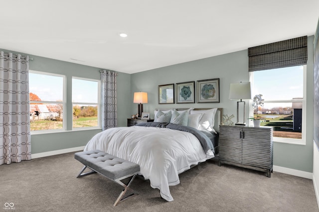 carpeted bedroom featuring baseboards