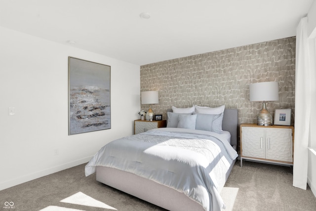 bedroom featuring carpet and baseboards