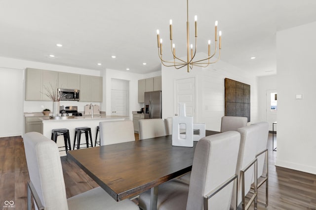 dining area featuring dark wood-style floors, recessed lighting, and an inviting chandelier