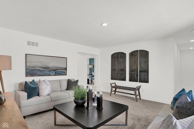 carpeted living room with recessed lighting, baseboards, and visible vents