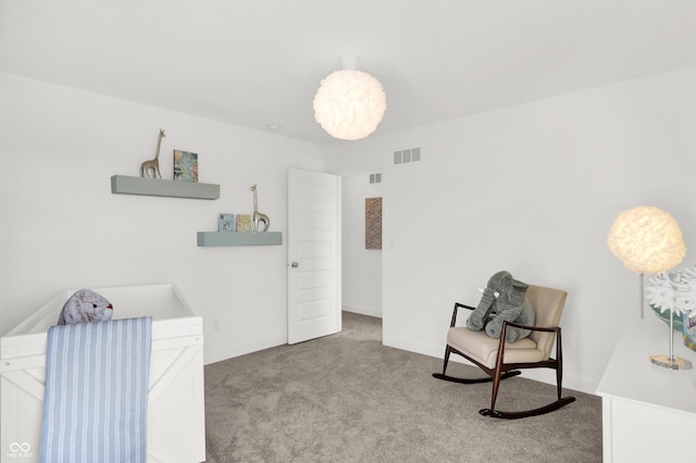 sitting room with carpet, visible vents, and baseboards