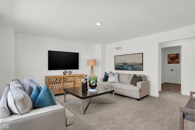 living room featuring visible vents, baseboards, and carpet floors