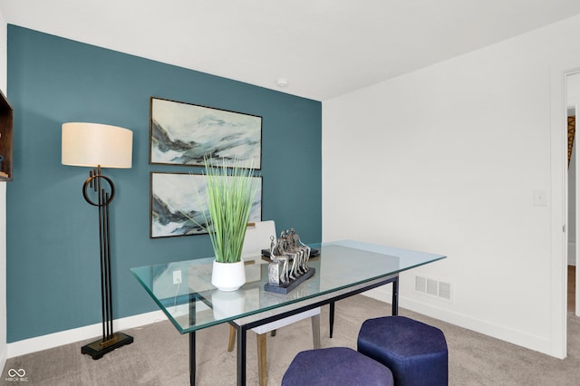 carpeted home office with visible vents and baseboards