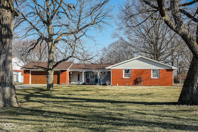 rear view of house featuring brick siding, an attached garage, and a lawn