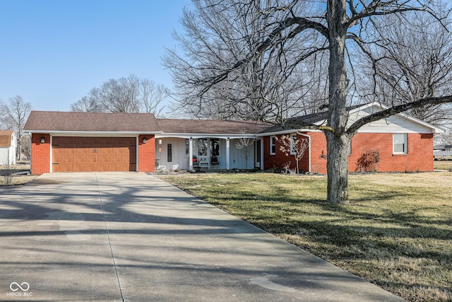 single story home with a front lawn, a garage, brick siding, and driveway