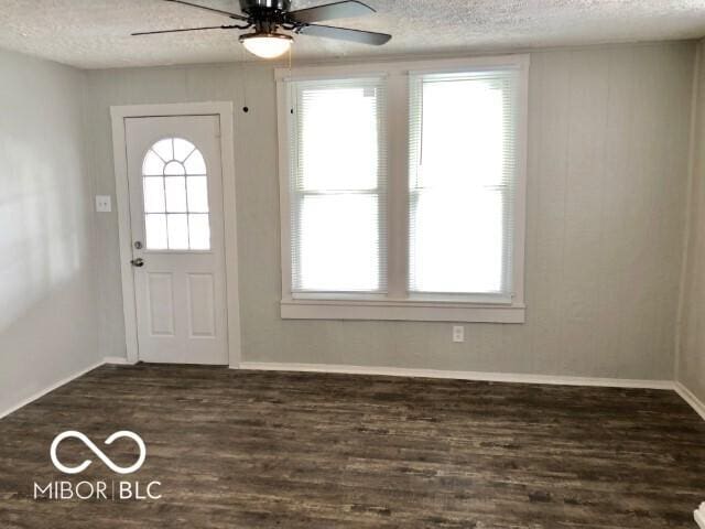 entrance foyer with dark wood-style floors, baseboards, a textured ceiling, and ceiling fan