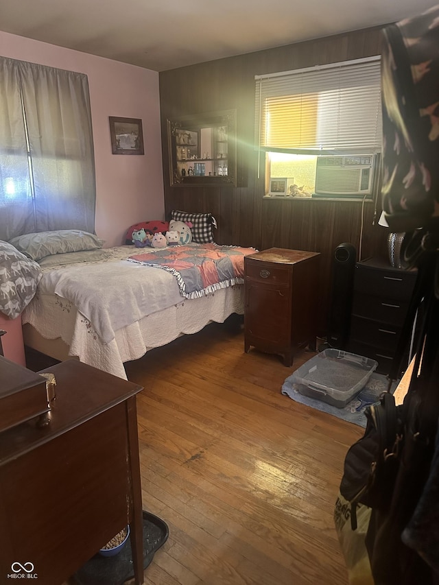 bedroom featuring cooling unit and hardwood / wood-style flooring