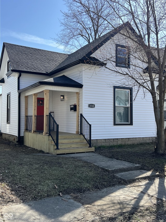 view of front of home with a porch and a shingled roof