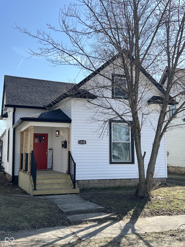 view of front of property with covered porch and a shingled roof