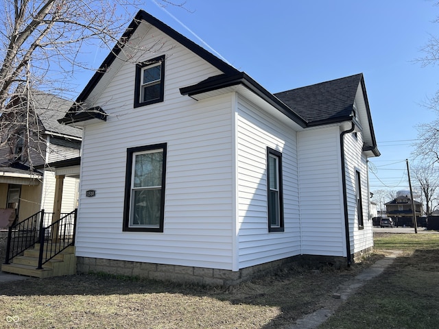 view of property exterior featuring a shingled roof