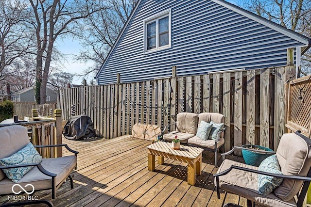 wooden terrace featuring an outdoor living space and fence