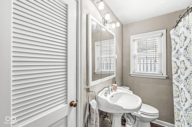 full bath featuring toilet and a sink