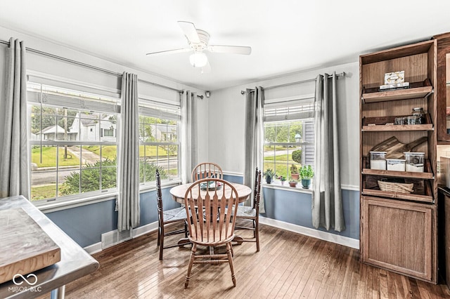 dining space with hardwood / wood-style floors, baseboards, and ceiling fan