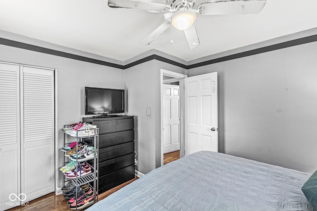 bedroom with a closet, a ceiling fan, and wood finished floors