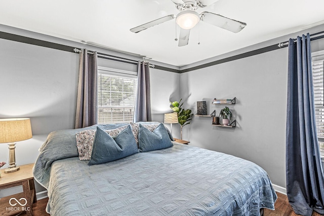 bedroom featuring baseboards, ceiling fan, and wood finished floors