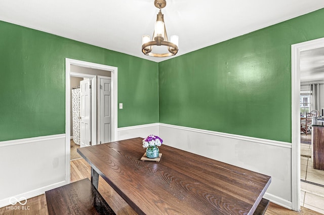 dining area with a notable chandelier and wood finished floors