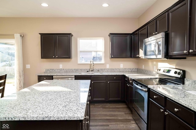 kitchen featuring a sink, stainless steel appliances, a kitchen island, and recessed lighting