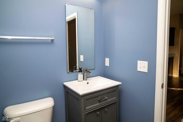 half bathroom with toilet and vanity