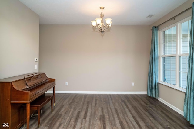 interior space featuring visible vents, baseboards, dark wood-style flooring, and a chandelier