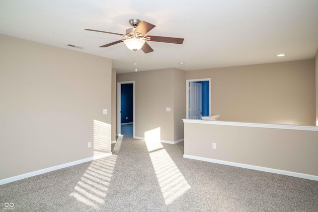 empty room featuring visible vents, baseboards, and ceiling fan