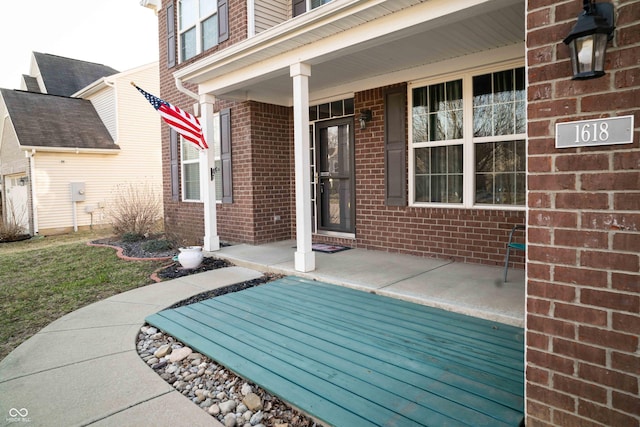 exterior space featuring brick siding and a porch