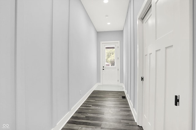 corridor with recessed lighting, baseboards, and dark wood-style flooring