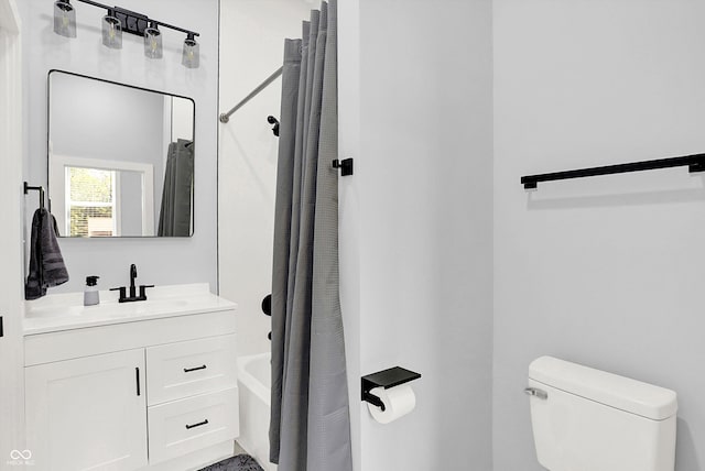 bathroom featuring shower / tub combo with curtain, toilet, and vanity