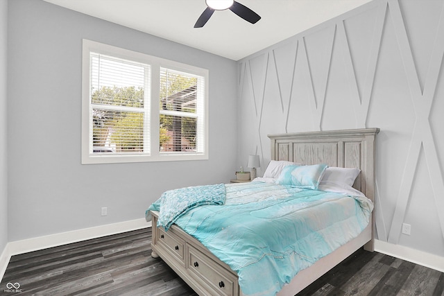 bedroom with dark wood finished floors, a ceiling fan, and baseboards