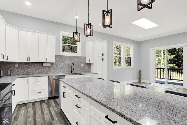 kitchen with dishwasher, decorative backsplash, electric range oven, and a sink