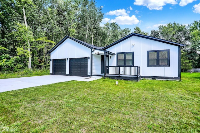 view of front of house featuring board and batten siding, a front lawn, driveway, crawl space, and an attached garage