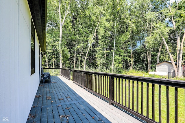 wooden terrace featuring a yard