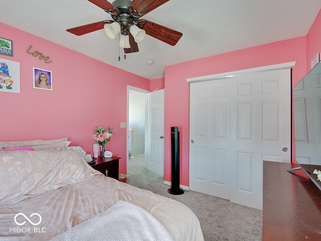 carpeted bedroom featuring a closet and ceiling fan