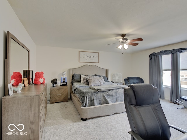 bedroom featuring light colored carpet and ceiling fan