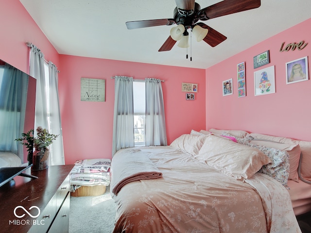 carpeted bedroom featuring multiple windows and ceiling fan