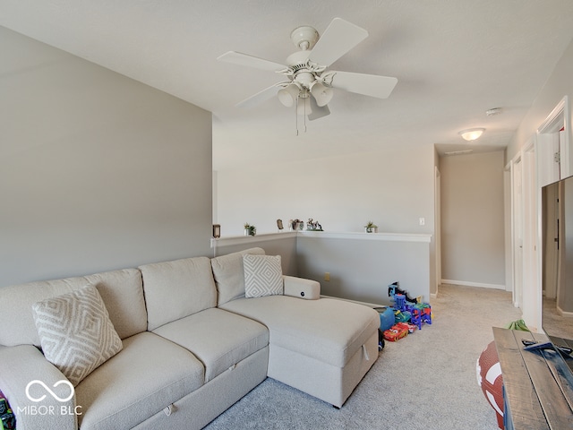 carpeted living room featuring baseboards and ceiling fan