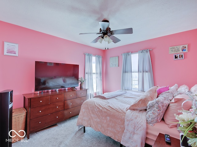 bedroom with a ceiling fan and carpet flooring