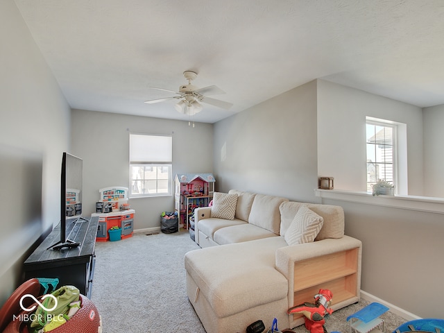 living room with baseboards, carpet, and ceiling fan