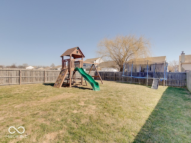 view of jungle gym with a fenced backyard, a lawn, and a trampoline