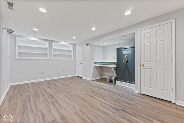 interior space featuring recessed lighting, baseboards, and wood finished floors