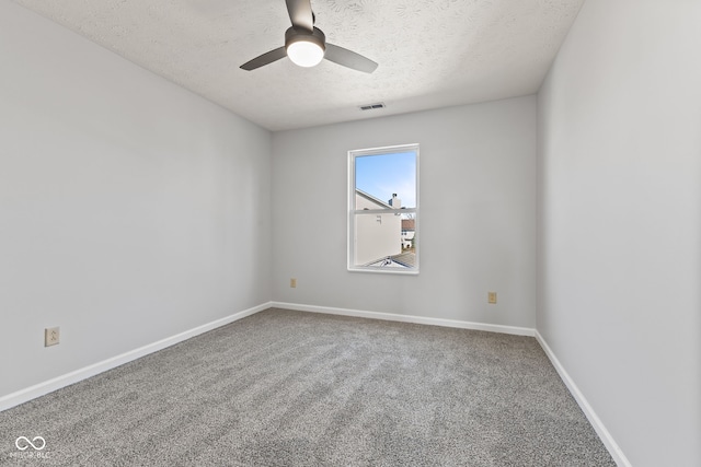 carpeted empty room featuring visible vents, baseboards, a textured ceiling, and a ceiling fan