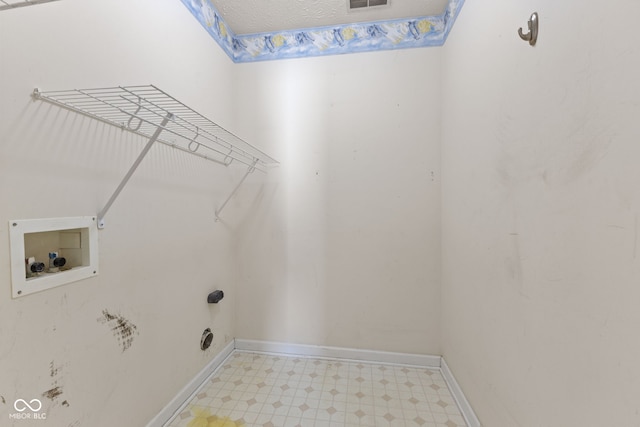 clothes washing area featuring washer hookup, a textured ceiling, baseboards, light floors, and laundry area