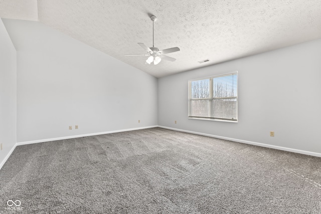 spare room featuring visible vents, baseboards, ceiling fan, lofted ceiling, and carpet floors