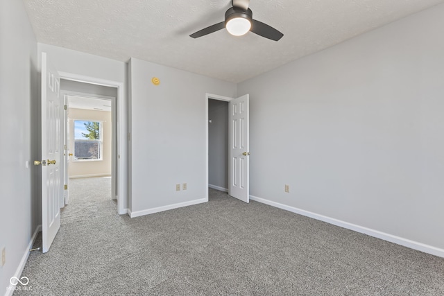 unfurnished bedroom featuring baseboards, carpet, a ceiling fan, and a textured ceiling