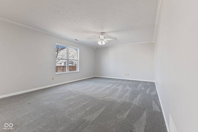 unfurnished room with ornamental molding, a ceiling fan, a textured ceiling, carpet floors, and baseboards